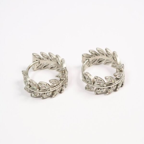 The Alloro Earrings are a refined expression of Italian heritage and timeless beauty. Inspired by the laurel wreath—an ancient symbol of victory and honor—these earrings are crafted with delicate leaf motifs and shimmering stones. Available in both gold-plated and silver finishes, they bring a graceful balance of classic design and modern sparkle. Perfect on their own or paired with the matching Alloro Ring, they embody elegance and strength for every occasion.