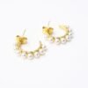 The Mezza Luna earrings capture the serene beauty of the moon in a delicate gold-plated half-hoop design. Adorned with a row of luminous pearls, these earrings are a graceful balance of simplicity and refinement. Their versatile style makes them the perfect choice for both everyday elegance and special occasions.