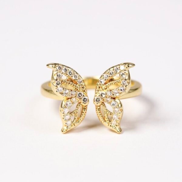The Farfalla Ring captures the delicate beauty of a butterfly in flight, symbolizing transformation, lightness, and freedom. Crafted in gold-plated brilliance and adorned with sparkling stones, its wings shimmer with every movement, offering a perfect blend of elegance and radiance. A timeless piece that celebrates grace and resilience, Farfalla is designed to inspire and enchant.
