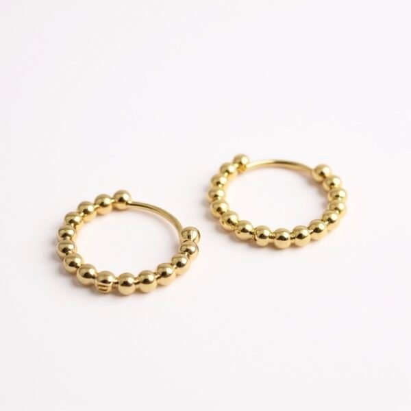 Minimalist yet luminous, the Luce Dorata hoops are crafted gold-plated with a chic beaded design that captures light from every angle. Their versatile silhouette transitions seamlessly from casual elegance to evening sophistication, making them a staple in any jewelry collection. A timeless expression of radiance and refined Italian style.