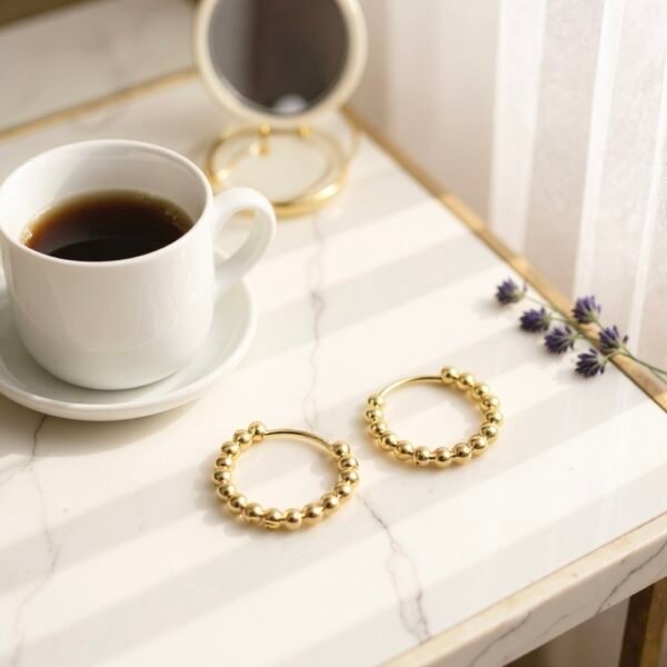 Minimalist yet luminous, the Luce Dorata hoops are crafted gold-plated with a chic beaded design that captures light from every angle. Their versatile silhouette transitions seamlessly from casual elegance to evening sophistication, making them a staple in any jewelry collection. A timeless expression of radiance and refined Italian style.