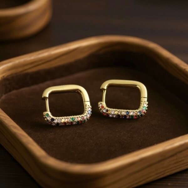 Bring a burst of color to your everyday style with the Arcobaleno Earrings, a celebration of vibrant beauty. Crafted in gold-plated brass, these rectangular hoops are adorned with multicolored crystal stones that sparkle with every movement. Perfect for both casual chic and evening glamour, they add a playful yet elegant touch to your look. Lightweight, versatile, and radiant, the Arcobaleno Earrings are the perfect accessory to brighten your day.
