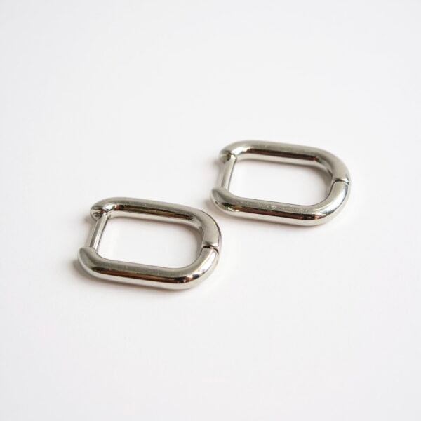 The Argento Puro earrings embody sleek sophistication with their minimalist rectangular hoop silhouette in high-polished sterling silver. Designed for those who love understated elegance, these versatile earrings transition seamlessly from day to night, adding a refined edge to any look. Their lightweight design ensures comfort, while their timeless finish makes them a staple piece for your jewelry collection.