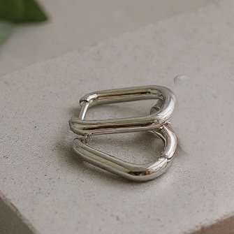 The Argento Puro earrings embody sleek sophistication with their minimalist rectangular hoop silhouette in high-polished sterling silver. Designed for those who love understated elegance, these versatile earrings transition seamlessly from day to night, adding a refined edge to any look. Their lightweight design ensures comfort, while their timeless finish makes them a staple piece for your jewelry collection.
