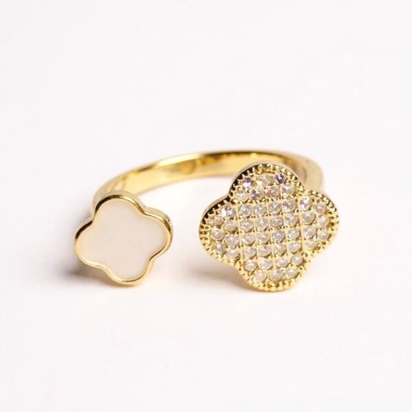 The Quadrifoglio ring celebrates the rarity of the four-leaf clover, a universal symbol of luck, hope, and faith. One clover gleams with dazzling cubic zirconia, while the other glows with a soft mother-of-pearl inlay — a balance of brilliance and serenity. The open band design allows for an adjustable fit, making it as versatile as it is meaningful. Expertly crafted in gold-plated brass, this ring is a refined token of elegance and good fortune, perfect for everyday wear or as a thoughtful gift.
