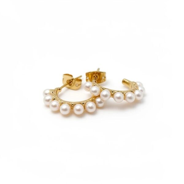 "Mezza Luna" Half the moon, all the elegance. The Mezza Luna earrings capture the serene beauty of the moon in a delicate gold-plated half-hoop design. Adorned with a row of luminous pearls, these earrings are a graceful balance of simplicity and refinement. Their versatile style makes them the perfect choice for both everyday elegance and special occasions.