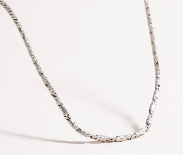 The Catena Argento is a timeless silver chain necklace crafted to embody both strength and simplicity. Its sleek links reflect understated elegance, making it the perfect piece for layering or wearing alone. Whether styled for everyday sophistication or paired with a statement pendant, this chain serves as a versatile foundation in any jewelry collection. Made with high-quality silver plating, the Catena Argento captures the balance between durability and refinement.