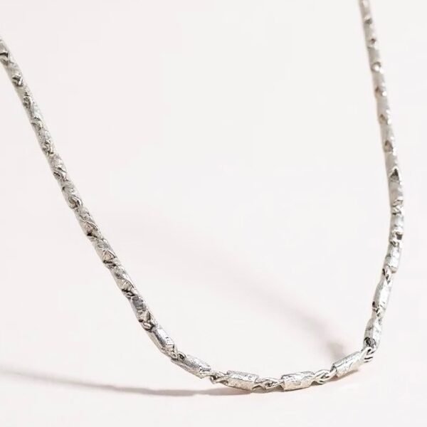 The Catena Argento is a timeless silver chain necklace crafted to embody both strength and simplicity. Its sleek links reflect understated elegance, making it the perfect piece for layering or wearing alone. Whether styled for everyday sophistication or paired with a statement pendant, this chain serves as a versatile foundation in any jewelry collection. Made with high-quality silver plating, the Catena Argento captures the balance between durability and refinement.
