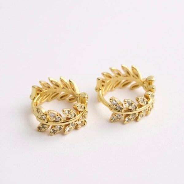 The Alloro Earrings are a refined expression of Italian heritage and timeless beauty. Inspired by the laurel wreath—an ancient symbol of victory and honor—these earrings are crafted with delicate leaf motifs and shimmering stones. Available in both gold-plated and silver finishes, they bring a graceful balance of classic design and modern sparkle. Perfect on their own or paired with the matching Alloro Ring, they embody elegance and strength for every occasion.