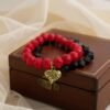 The Angalia Cuore bracelet is handcrafted with luminous red facted crystal beads, finished with a gleaming gold-plated heart charm etched in leopard detail. A radiant symbol of fierce love and fearless style, this bracelet is designed to catch the light and elevate any look. Whether worn solo as a statement piece or stacked for extra drama, Angalia Cuore is elegance with an edge. This bracelet looks beautiful on its own but truly shines when stacked with the classic black beaded bracelet. The bold red and gold heart charm create a striking contrast when paired with black, making it perfect for day-to-night elegance.