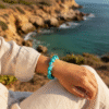 Inspired by the endless blue of the Mediterranean, the Mare Azzurro bracelet features natural turquoise stones, each uniquely shaped to highlight their raw beauty. Symbolizing protection, strength, and serenity, this bracelet carries the timeless energy of the ocean. Perfect for those who feel most at peace near the water, it’s a statement of both grounding and freedom.