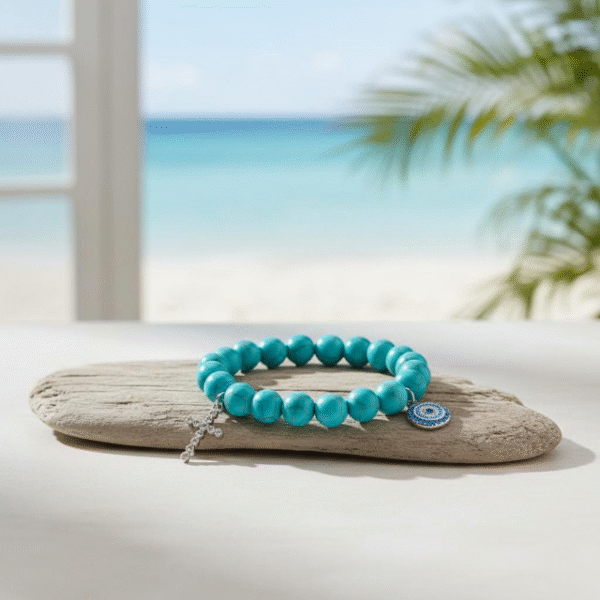 The Mare Azzurro – Croce bracelet blends the tranquil beauty of turquoise beads with symbols of faith and protection. Featuring a silver sparkling cross charm and a pavé-style evil eye medallion, this bracelet carries both elegance and meaning. The soothing blue tones evoke the Mediterranean Sea, while the charms symbolize strength, blessing, and spiritual guidance. Wear it on its own or stack it with other Mare Azzurro pieces for a layered look filled with light and faith.