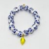Infused with the zest and sunshine of Italy, the Limoncello Bracelet captures the joyful spirit of the Amalfi Coast. Featuring hand-painted blue and white floral ceramic-style beads accented with a vibrant lemon charm, this piece embodies both playful elegance and timeless Italian charm. Perfect on its own or stacked for a bold Mediterranean statement, Limoncello adds a refreshing touch of la dolce vita to any look.