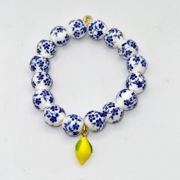 Infused with the zest and sunshine of Italy, the Limoncello Bracelet captures the joyful spirit of the Amalfi Coast. Featuring hand-painted blue and white floral ceramic-style beads accented with a vibrant lemon charm, this piece embodies both playful elegance and timeless Italian charm. Perfect on its own or stacked for a bold Mediterranean statement, Limoncello adds a refreshing touch of la dolce vita to any look.