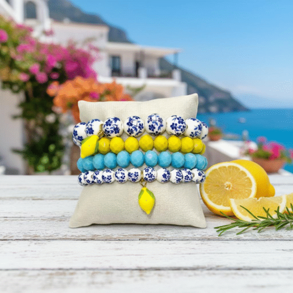 Fresh Elegance, Italian Charm. Infused with the zest and sunshine of Italy, the Limoncello Bracelet captures the joyful spirit of the Amalfi Coast. Featuring hand-painted blue and white floral ceramic-style beads accented with a vibrant lemon charm, this piece embodies both playful elegance and timeless Italian charm. Perfect on its own or stacked for a bold Mediterranean statement, Limoncello adds a refreshing touch of la dolce vita to any look.
