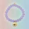 The Occhio Celeste bracelet radiates mystical beauty with faceted lavender crystals that capture light in every movement. At the heart of the bracelet hangs a gold-plated protective eye medallion with a radiant ruby-colored center, symbolizing clarity, intuition, and divine guidance. Whether worn solo for a touch of celestial elegance or stacked for bold expression, this bracelet serves as both a style statement and a talisman of light.