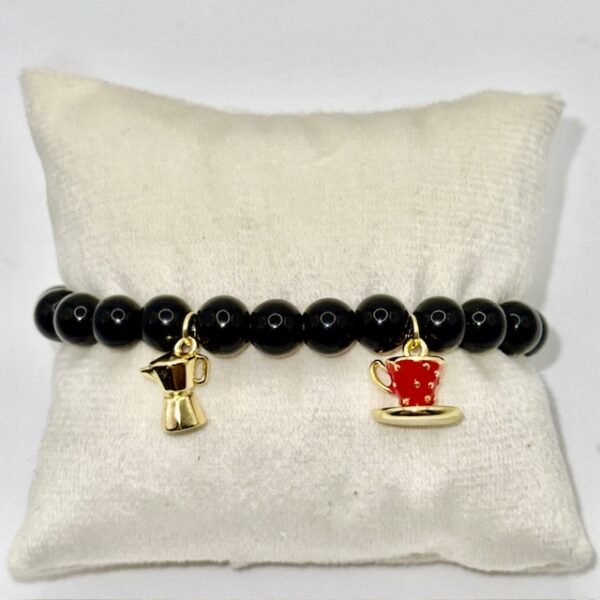 Inspired by Italy’s love affair with coffee, the Caffè Amore Bracelet pairs sleek black beads with two gold-plated charms — a moka pot and a red espresso cup — celebrating the warmth of a morning brew and the art of connection. Perfect for coffee lovers and anyone who treasures la dolce vita, this playful yet elegant bracelet adds a touch of Italian charm to any outfit.