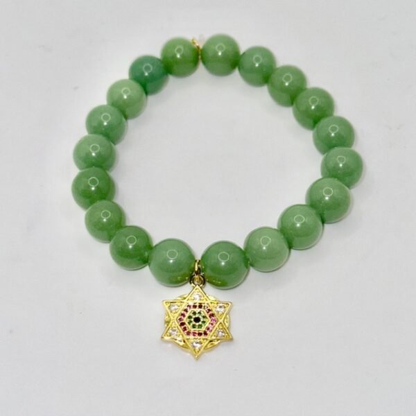 The Stella Verde bracelet features smooth green jade beads, paired with a radiant gold-plated Star of David charm accented in vibrant pink and green crystals. This piece embodies spiritual strength and balance, serving as a guiding light and a grounding connection to nature. Wear it alone for a statement of faith and serenity, or stack it for layered harmony.