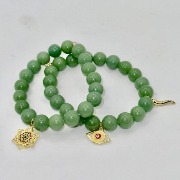 The Stella Verde bracelet features smooth green jade beads, paired with a radiant gold-plated Star of David charm accented in vibrant pink and green crystals. This piece embodies spiritual strength and balance, serving as a guiding light and a grounding connection to nature. Wear it alone for a statement of faith and serenity, or stack it for layered harmony.