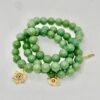 The Stella Verde bracelet features smooth green jade beads, paired with a radiant gold-plated Star of David charm accented in vibrant pink and green crystals. This piece embodies spiritual strength and balance, serving as a guiding light and a grounding connection to nature. Wear it alone for a statement of faith and serenity, or stack it for layered harmony.