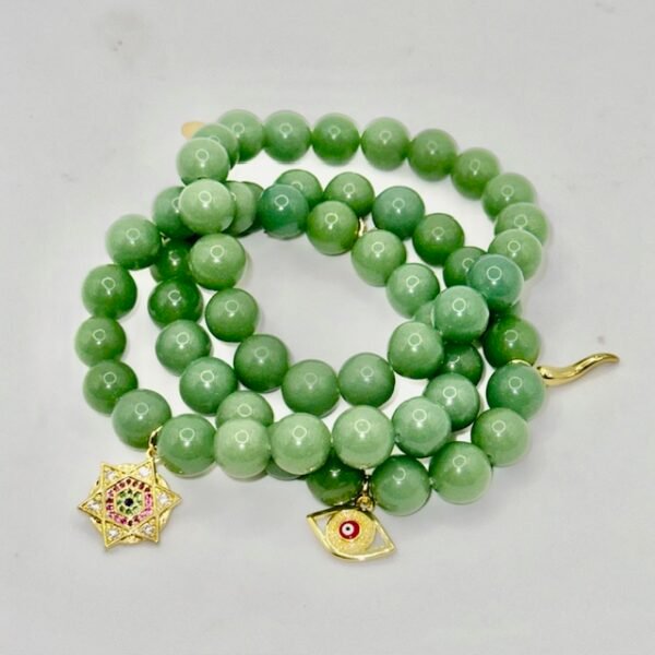 The Stella Verde bracelet features smooth green jade beads, paired with a radiant gold-plated Star of David charm accented in vibrant pink and green crystals. This piece embodies spiritual strength and balance, serving as a guiding light and a grounding connection to nature. Wear it alone for a statement of faith and serenity, or stack it for layered harmony.