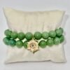 The Stella Verde bracelet features smooth green jade beads, paired with a radiant gold-plated Star of David charm accented in vibrant pink and green crystals. This piece embodies spiritual strength and balance, serving as a guiding light and a grounding connection to nature. Wear it alone for a statement of faith and serenity, or stack it for layered harmony.