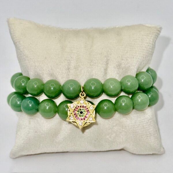 The Stella Verde bracelet features smooth green jade beads, paired with a radiant gold-plated Star of David charm accented in vibrant pink and green crystals. This piece embodies spiritual strength and balance, serving as a guiding light and a grounding connection to nature. Wear it alone for a statement of faith and serenity, or stack it for layered harmony.