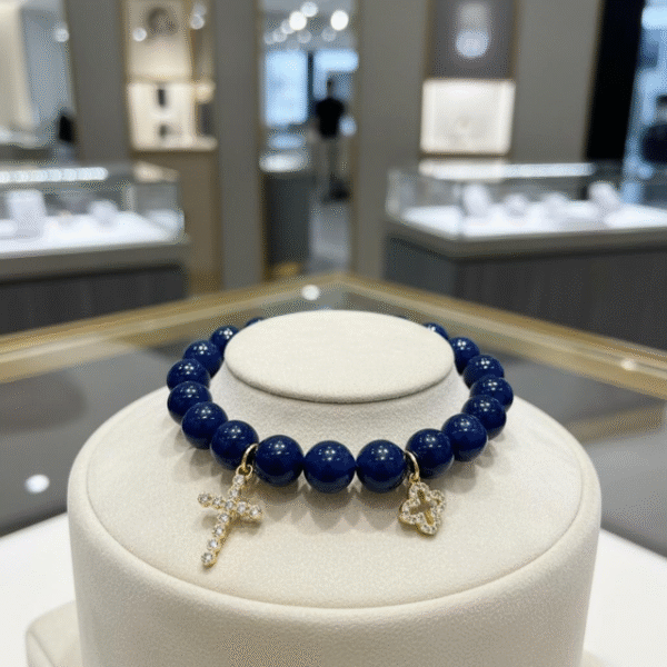The Fede Blu Bracelet embodies timeless devotion and elegance. Crafted with deep blue polished beads, it symbolizes serenity and strength. Accented with two gold-plated charms—a sparkling pavé cross and a delicate quatrefoil—it represents faith, balance, and divine protection. Whether worn alone or stacked with complementary designs, this bracelet brings a touch of Italian sophistication and spiritual meaning to every moment. Pair the Fede Blu Bracelet with the Verde Classico Bracelet for a bold yet harmonious combination. The deep navy blue beads of Fede Blu reflect wisdom and strength, while the rich green tones of Verde Classico symbolize renewal and prosperity. Together, accented with gold-plated charms of faith and fortune, this stack becomes a powerful expression of balance, protection, and timeless Italian elegance. Wear them stacked for a statement look that transitions seamlessly from day to evening.