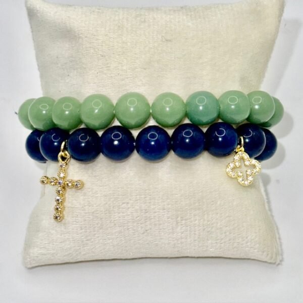 The Fede Blu Bracelet embodies timeless devotion and elegance. Crafted with deep blue polished beads, it symbolizes serenity and strength. Accented with two gold-plated charms—a sparkling pavé cross and a delicate quatrefoil—it represents faith, balance, and divine protection. Whether worn alone or stacked with complementary designs, this bracelet brings a touch of Italian sophistication and spiritual meaning to every moment. Pair the Fede Blu Bracelet with the Verde Classico Bracelet for a bold yet harmonious combination. The deep navy blue beads of Fede Blu reflect wisdom and strength, while the rich green tones of Verde Classico symbolize renewal and prosperity. Together, accented with gold-plated charms of faith and fortune, this stack becomes a powerful expression of balance, protection, and timeless Italian elegance. Wear them stacked for a statement look that transitions seamlessly from day to evening.