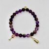 Raise a toast to elegance with the Vino Bliss Bracelet. Crafted with rich amethyst stones, this bracelet is adorned with playful gold-plated wine glass and champagne bottle charms — a sparkling nod to life’s joyful moments. Whether worn alone or stacked, it’s a stylish reminder to savor the sweetness of every day. For a chic statement stack it with the lilac crystal faceted bracelet for a layered look that’s both vibrant and celebratory. Together, they capture the perfect blend of sophistication and fun.