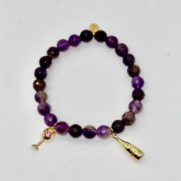 Raise a toast to elegance with the Vino Bliss Bracelet. Crafted with rich amethyst stones, this bracelet is adorned with playful gold-plated wine glass and champagne bottle charms — a sparkling nod to life’s joyful moments. Whether worn alone or stacked, it’s a stylish reminder to savor the sweetness of every day. For a chic statement stack it with the lilac crystal faceted bracelet for a layered look that’s both vibrant and celebratory. Together, they capture the perfect blend of sophistication and fun.