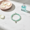 The Amore di Bellezza bracelet is designed as a symbol of devotion and elegance. Crafted with beads natural stone beads—choose from soft rose jade or calming green jade—each piece is accented with a delicate heart-shaped lock charm gold-plated or silver-toned. Sold individually, these bracelets are perfect on their own but even more striking when stacked together, allowing you to mix colors and finishes for a personalized statement of love and beauty.