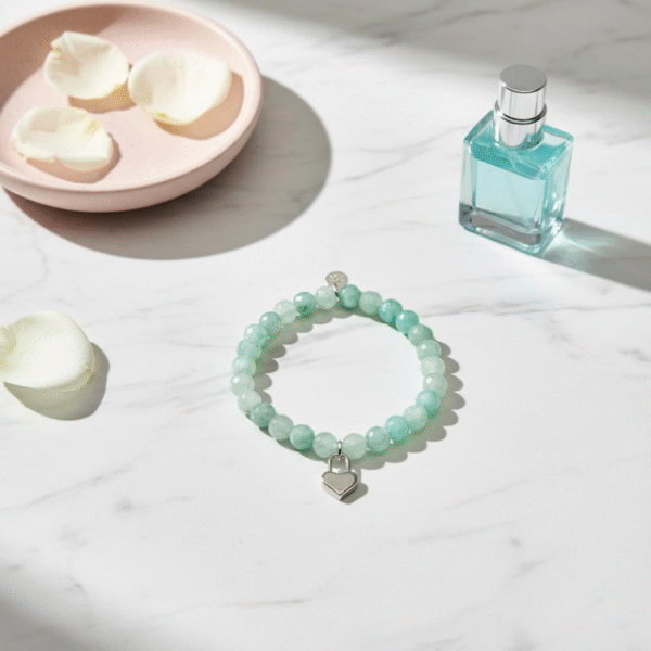 The Amore di Bellezza bracelet is designed as a symbol of devotion and elegance. Crafted with beads natural stone beads—choose from soft rose jade or calming green jade—each piece is accented with a delicate heart-shaped lock charm gold-plated or silver-toned. Sold individually, these bracelets are perfect on their own but even more striking when stacked together, allowing you to mix colors and finishes for a personalized statement of love and beauty.