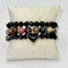 The Cuore di Terra bracelet combines the natural beauty of earthy Rhodonite stones with a striking black heart charm, symbolizing balance, protection, and enduring love. The grounding tones of brown, rose, and black reflect the richness of the earth, while the gold-plated-framed enamel heart adds a touch of modern elegance. Perfect on its own or stacked with crystal accents, this bracelet is a versatile piece that carries both strength and sophistication.