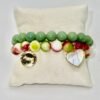 Dolce Amor, or Sweet Love in Beauty, is a joyful celebration of love and life. Designed with vibrant watermelon jade stones in refreshing shades of green, white, and pink, this bracelet captures the freshness of gelato and the warmth of affection. A luminous mother-of-pearl heart charm, gold-plated framed, and Amor gold-plated charm symbolizes purity, devotion, and timeless love. Playful yet elegant, it’s the perfect piece to wear alone or stacked with other Bella Pia favorites for a bold expression of amore.