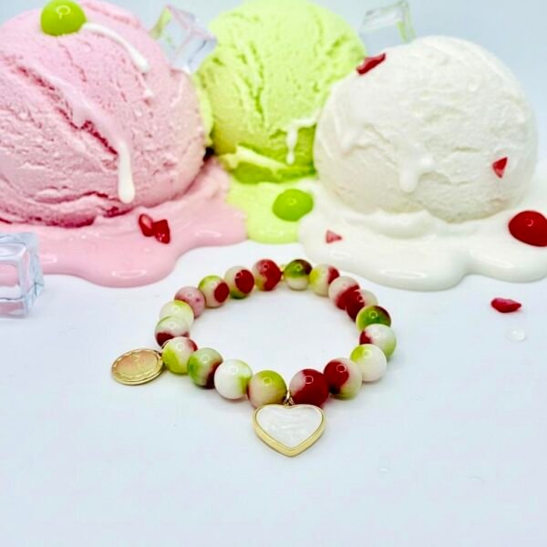 Dolce Amor, or Sweet Love in Beauty, is a joyful celebration of love and life. Designed with vibrant watermelon jade stones in refreshing shades of green, white, and pink, this bracelet captures the freshness of gelato and the warmth of affection. A luminous mother-of-pearl heart charm, gold-plated framed, and Amor gold-plated charm symbolizes purity, devotion, and timeless love. Playful yet elegant, it’s the perfect piece to wear alone or stacked with other Bella Pia favorites for a bold expression of amore.