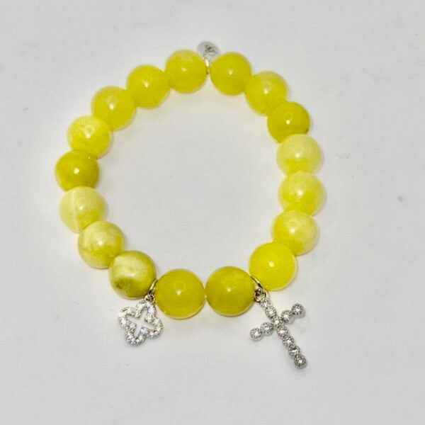 The Sole Benedetto bracelet radiates light and protection. Crafted from vibrant yellow jade stones, it carries the warmth and positivity of the sun. Accented with a sparkling silver pavé cross and a shimmering silver quadrifoglio (four-leaf clover), this piece is a powerful symbol of faith, luck, and divine blessings. Whether worn alone or stacked, it is a timeless reminder of grace and strength.