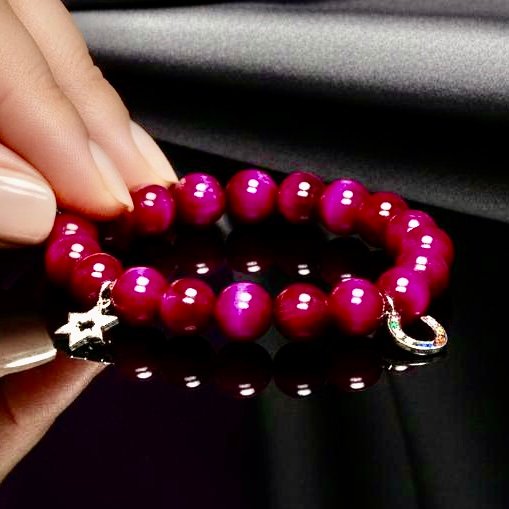 Celebrate heritage, unity, and strength with our Star of David Bracelet. Featuring vibrant magenta stone beads, this bracelet is adorned with a silver sparkling Star of David charm and a silver horseshoe for luck. A meaningful piece that intertwines tradition with contemporary elegance, it offers both protection and beauty in every detail. Wear it solo as a bold expression of faith, or stack it with the green jade bracelet for a striking contrast that symbolizes balance, renewal, and protection.
