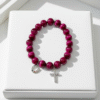 Celebrate heritage, unity, and strength with our Star of David Bracelet. Featuring vibrant magenta stone beads, this bracelet is adorned with a silver sparkling Star of David charm and a silver horseshoe for luck. A meaningful piece that intertwines tradition with contemporary elegance, it offers both protection and beauty in every detail. Wear it solo as a bold expression of faith, or stack it with the green jade bracelet for a striking contrast that symbolizes balance, renewal, and protection.