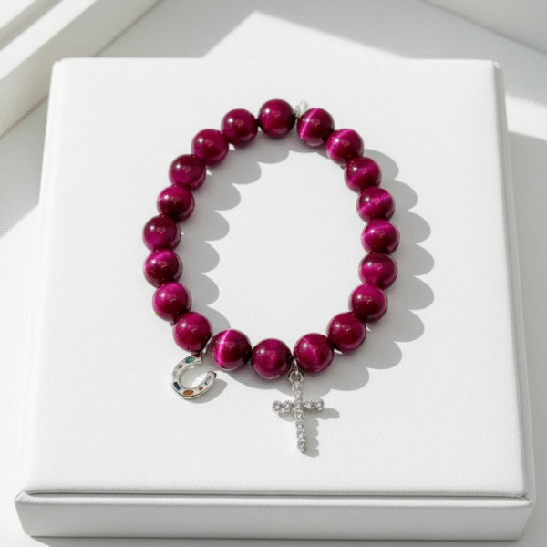 Celebrate heritage, unity, and strength with our Star of David Bracelet. Featuring vibrant magenta stone beads, this bracelet is adorned with a silver sparkling Star of David charm and a silver horseshoe for luck. A meaningful piece that intertwines tradition with contemporary elegance, it offers both protection and beauty in every detail. Wear it solo as a bold expression of faith, or stack it with the green jade bracelet for a striking contrast that symbolizes balance, renewal, and protection.