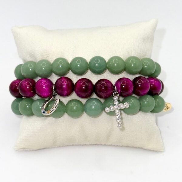 Embody faith and strength with our Cross Bracelet, crafted from rich magenta stones that radiate elegance and inner power. Accented with a delicate silver crystal-encrusted cross and a silver symbolic horseshoe charm, this bracelet blends timeless spirituality with a touch of fortune. A versatile piece that transitions seamlessly from everyday wear to special occasions, it’s designed to be both a symbol of devotion and a statement of style. Wear it solo as a bold expression of faith, or stack it with the green jade bracelet for a striking contrast that symbolizes balance, renewal, and protection.
