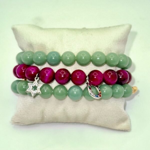 Celebrate heritage, unity, and strength with our Star of David Bracelet. Featuring vibrant magenta stone beads, this bracelet is adorned with a silver sparkling Star of David charm and a silver horseshoe for luck. A meaningful piece that intertwines tradition with contemporary elegance, it offers both protection and beauty in every detail. Wear it solo as a bold expression of faith, or stack it with the green jade bracelet for a striking contrast that symbolizes balance, renewal, and protection.