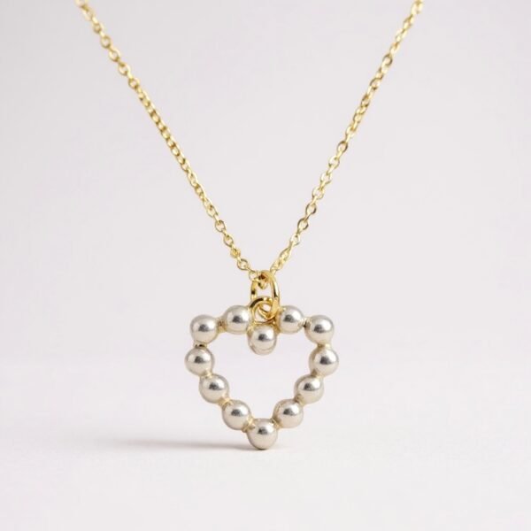The Aurora Mini is a delicate symbol of love and light, designed with petite pearls set in a graceful heart silhouette. Perfect for layering or wearing as a subtle statement, this necklace embodies timeless beauty in a refined, minimalist form. Available in both gold-plated and silver finishes, it’s a versatile piece that shines with quiet elegance.