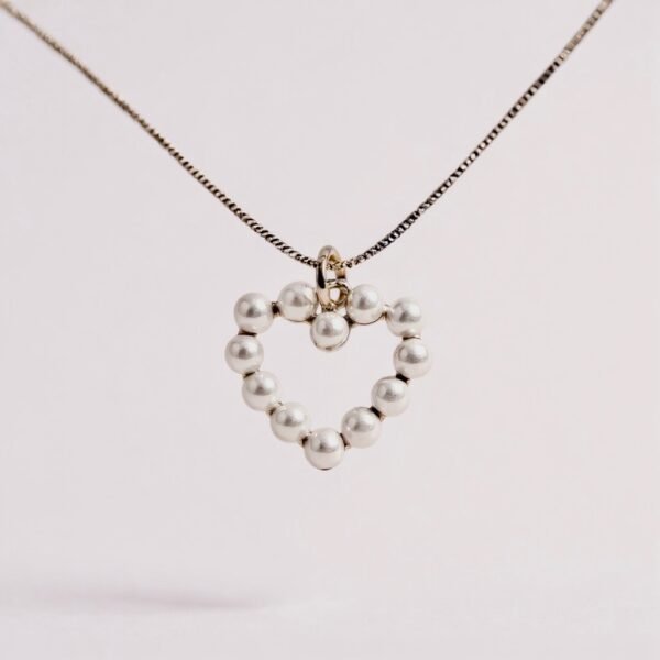 The Aurora Mini is a delicate symbol of love and light, designed with petite pearls set in a graceful heart silhouette. Perfect for layering or wearing as a subtle statement, this necklace embodies timeless beauty in a refined, minimalist form. Available in both gold-plated and silver finishes, it’s a versatile piece that shines with quiet elegance.