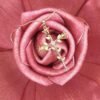 The Rosario Necklace beautifully intertwines devotion and nature’s elegance. Crafted in gold-plated, this pendant forms a cross made of delicate rose blooms, symbolizing love, faith, and eternal beauty. A sparkling center stone adds a touch of brilliance, making it both a meaningful keepsake and a timeless accessory. Perfect for those who want to carry faith and grace close to their heart.