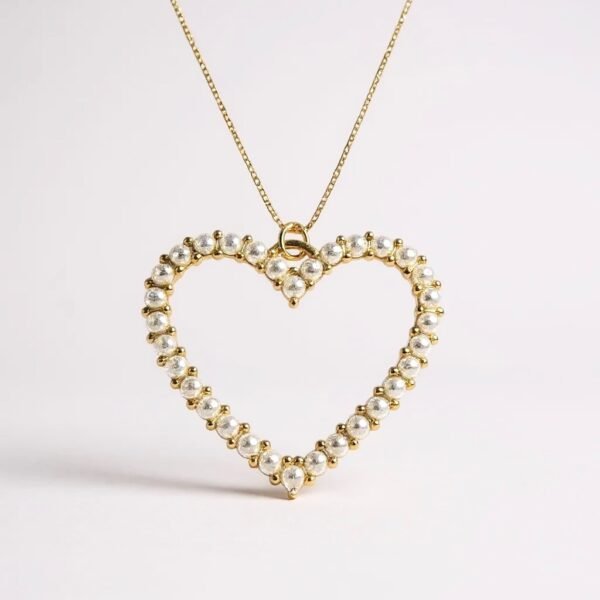 The Aurora Heart Necklace is a timeless expression of love and grace. Designed with luminous pearls delicately set in radiant gold-plated, this open-heart silhouette captures the soft beauty of dawn — where elegance meets new beginnings. A versatile piece that elevates everyday wear and enhances special occasions, it’s a keepsake that speaks from the heart.