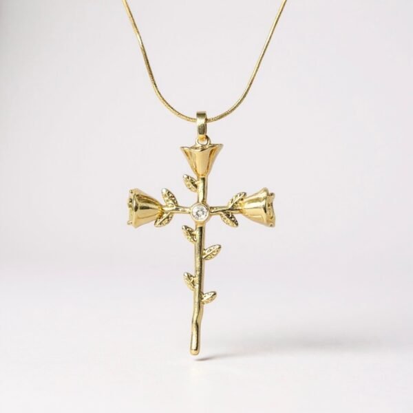 The Rosario Necklace beautifully intertwines devotion and nature’s elegance. Crafted in gold-plated, this pendant forms a cross made of delicate rose blooms, symbolizing love, faith, and eternal beauty. A sparkling center stone adds a touch of brilliance, making it both a meaningful keepsake and a timeless accessory. Perfect for those who want to carry faith and grace close to their heart.