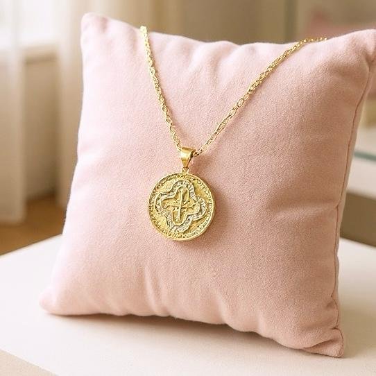 The Benedetta necklace captures timeless grace with a gold-plated round medallion pendant, intricately detailed with a radiant cross framed in shimmering crystals. Inspired by devotion and elegance, this piece blends strength of faith with classic Italian artistry. A meaningful heirloom design to wear close to your heart, Benedetta is a symbol of protection, hope, and everlasting style.