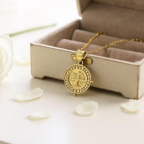 The Albero d’Oro Necklace embodies the eternal Tree of Life, a timeless symbol of growth, balance, and connection. Crafted in gold-plated elegance, the medallion features an intricately detailed tree framed with delicate crystal accents, catching the light with every movement. Perfect for layering or wearing solo, this piece carries a touch of heritage and a whisper of modern sophistication.