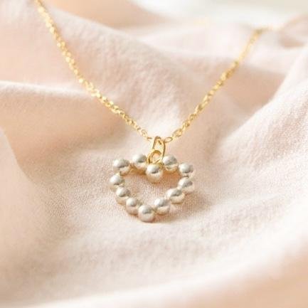 The Aurora Mini is a delicate symbol of love and light, designed with petite pearls set in a graceful heart silhouette. Perfect for layering or wearing as a subtle statement, this necklace embodies timeless beauty in a refined, minimalist form. Available in both gold-plated and silver finishes, it’s a versatile piece that shines with quiet elegance.